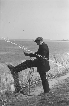 FISHERMAN MENDING NETS